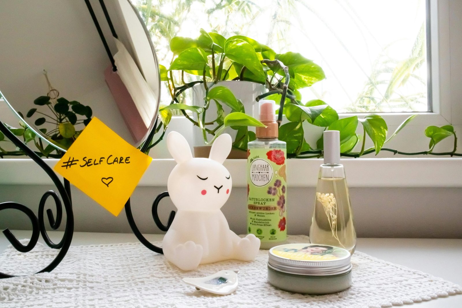 A soothing self-care corner with a bunny lamp, cosmetics, and a mirror, perfect for a relaxing routine.