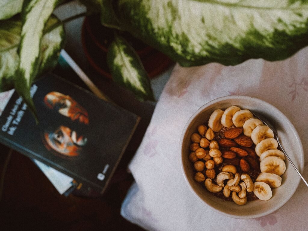 A nutritious breakfast bowl featuring bananas, nuts, and seeds in a cozy setting.